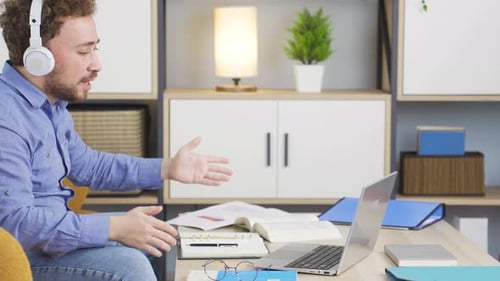 Excited Man Working on Laptop at Home