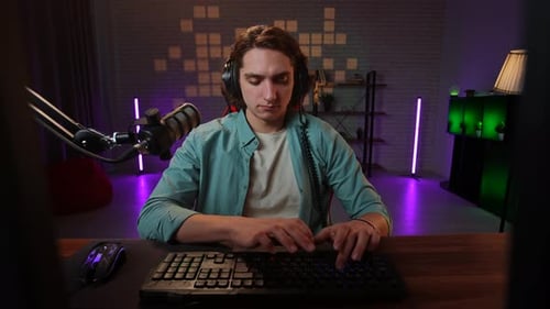 Young Adult Typing at Computer in Modern Room