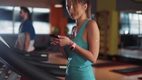 Young Woman on Treadmill Use Phone in Gym Sunlight Sportsman Sport Fitness Internet Face Technology
