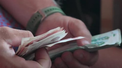 Counting Money: Man's Hands Counting Stack of Banknotes