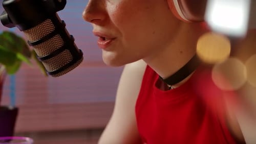 Young Adult Talking Into Microphone With Headphones