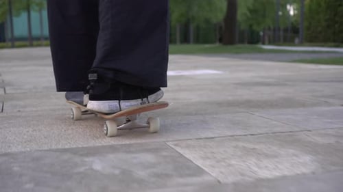 A Man Rides a Skateboard Legs and a Skate Closeup