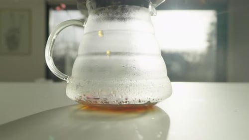 Steaming Coffee Brewing in Glass Carafe Indoors