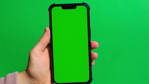 Hands Holding Cell Phone with Green Screen on Green Background
