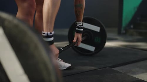 Fit Woman Performs Overhead Squat with Barbell at Sunny Outdoor Gym Tattooed Female Weightlifter