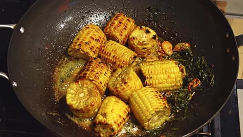 Delicious Grilled Corn Cooking in Wok with Herbs