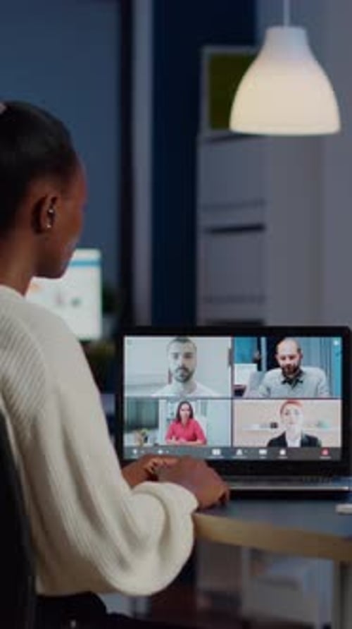 African Employee Working Overtime From Business Office Late at Night Discussing