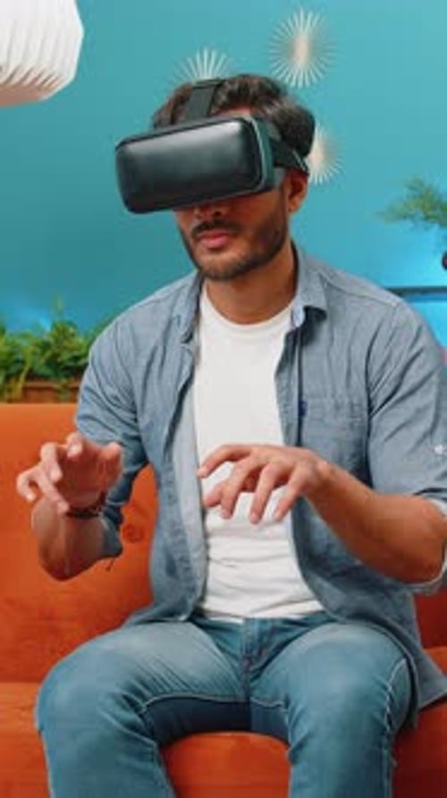 Young Man Experiencing Virtual Reality on Couch at Home