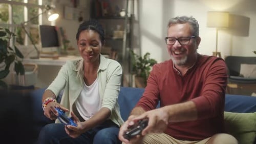 Woman and Man Playing Video Games on Couch