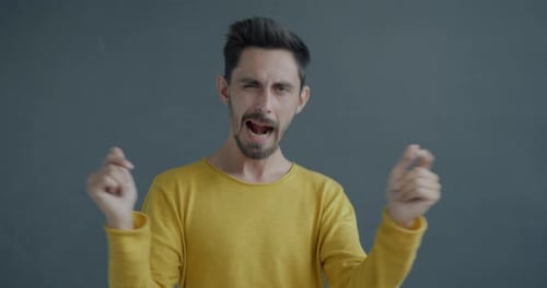 Man in Yellow Sweater Dancing and Singing