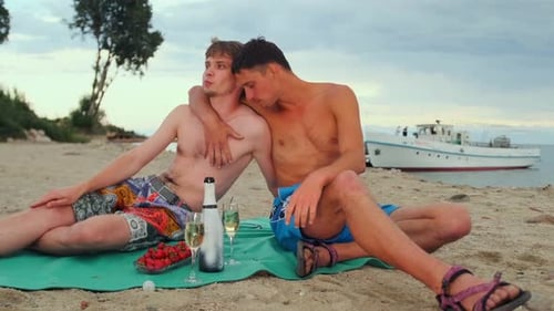 Romantic Couple Enjoying Champagne on a Sandy Beach