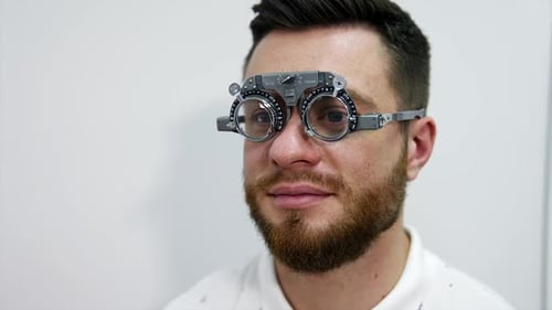 Man Wearing Eye Exam Phoropter Indoors
