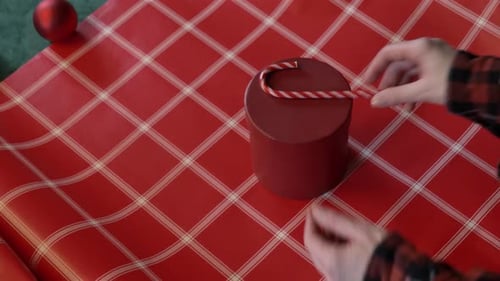 Wrapping Christmas Gift with Candy Cane and Pine