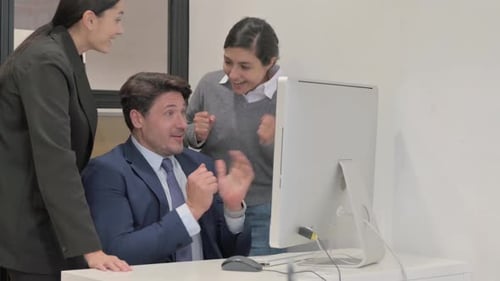 Colleagues Celebrating Success at Office Computer