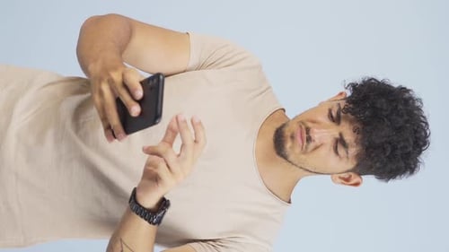 Young Adult Interacting with Mobile Phone in Portrait Mode