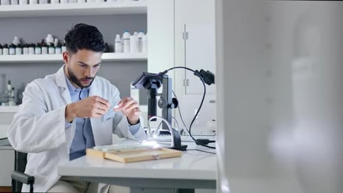 Scientist Preparing Sample on Glass Slide in Lab
