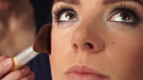 Makeup Artist Applying Rouge To Model Face