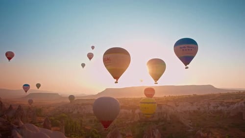 Hot Air Balloons Soar Over Desert at Sunrise