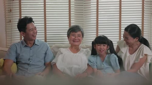 Family Togetherness on Sofa Smiling and Laughing