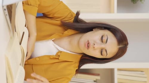 Woman Reads Book then Laughs at Phone Indoors