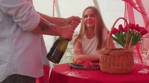 Man Opens Champagne for Romantic Date with Woman
