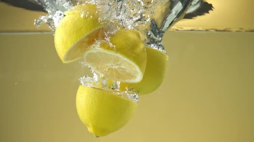Lemons Splashing into Water, Fresh Citrus Fruit