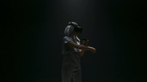 Young Woman Enjoys Virtual Reality in Dark Setting