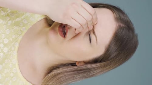 Young Woman Suffering From Headache and Fatigue