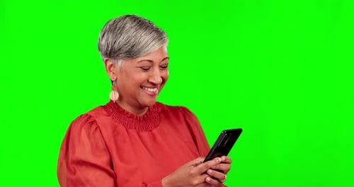 Phone, social media and green screen with a woman laughing in studio at a meme or joke