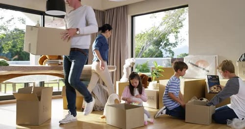 Family Unpacks Boxes After Moving into New Home