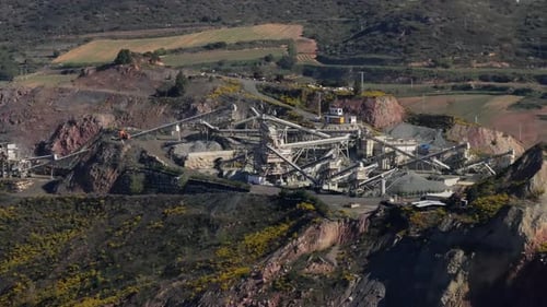 Aerial View of a Quarry Operation in a Mountainous Landscape Highlighting Industrial Activity and