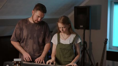 Girl Learns Piano With Instructor in Studio