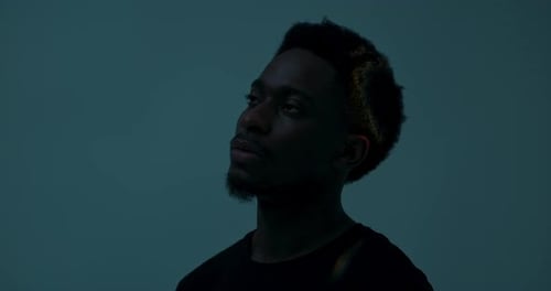 Abstract Concept African American Dark Skinned Man in Studio with Bright Light Isolated Handsome