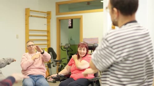 People in Wheelchairs Doing Arm Exercises with Instructor