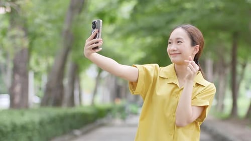 Woman Posing for Selfies in Urban Park