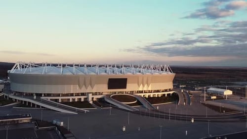 Modern Football Stadium Exterior at Sunset