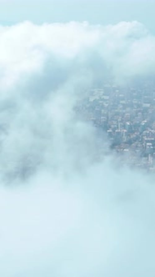 Vertical Video Timelapse Over the City with Clouds Moving Across a Scenic Sky and Stunning Urban