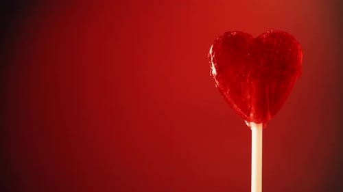 Red Heart Lollipop on Red Background