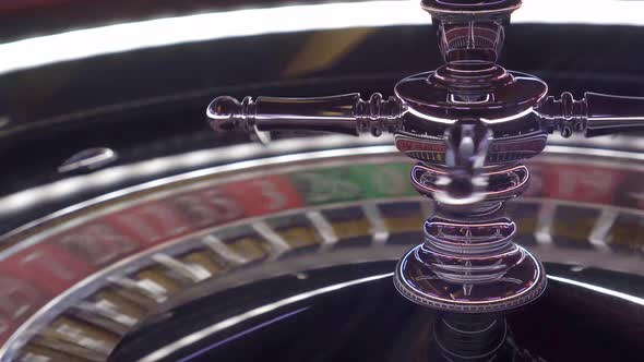 Close-up shot of a shiny silver European roulette wheel with red and ...