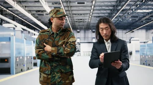 Soldier Speaks with Microchip Production Factory Senior Manager