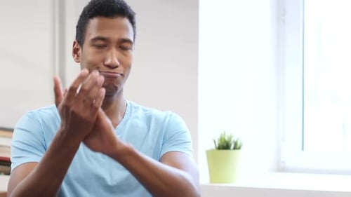 Young Adult Clapping in an Indoor Setting