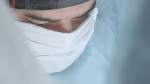 Doctor in Mask Prepares for Surgery in Hospital