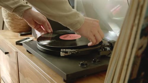 Placing Vinyl Record on Turntable to Listen Music