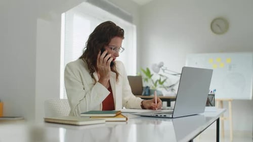 Caucasian Manager Calling Client on Phone in Office