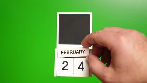 Hand Sets Calendar to February 24 on Green