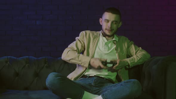 A Young Guy Playing Console Male Cybersport Play Games Online at Home ...