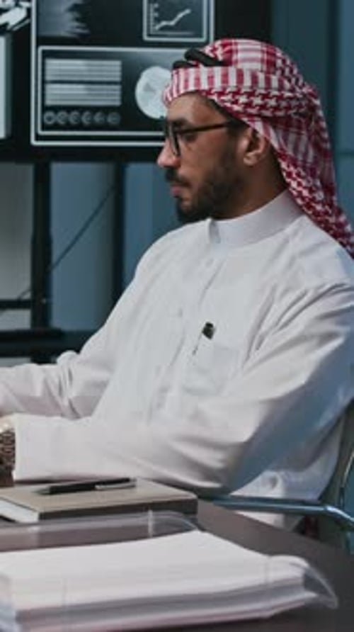 Middle Eastern Entrepreneur Talking on Phone at Office Space