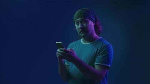 A Man is Browsing Social Networks Typing a Message on a Smartphone Thinking About the Text A