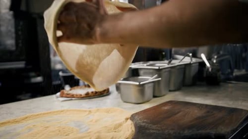 In Restaurant Professional Chef Preparing Pizza, Kneading Dough, flouring it. Cooking Delicious