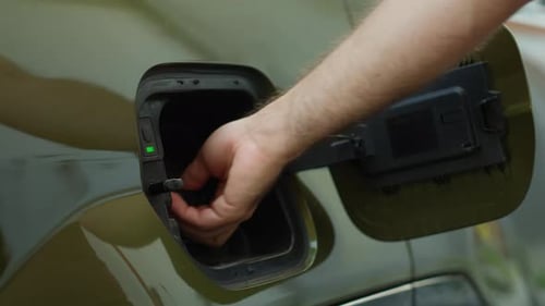 Close Up Shot of Driver Recharging EV Vehicle Battery Powering Electric Motor